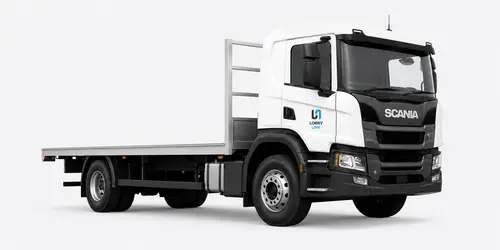 Flat deck truck carrying pallets and timber